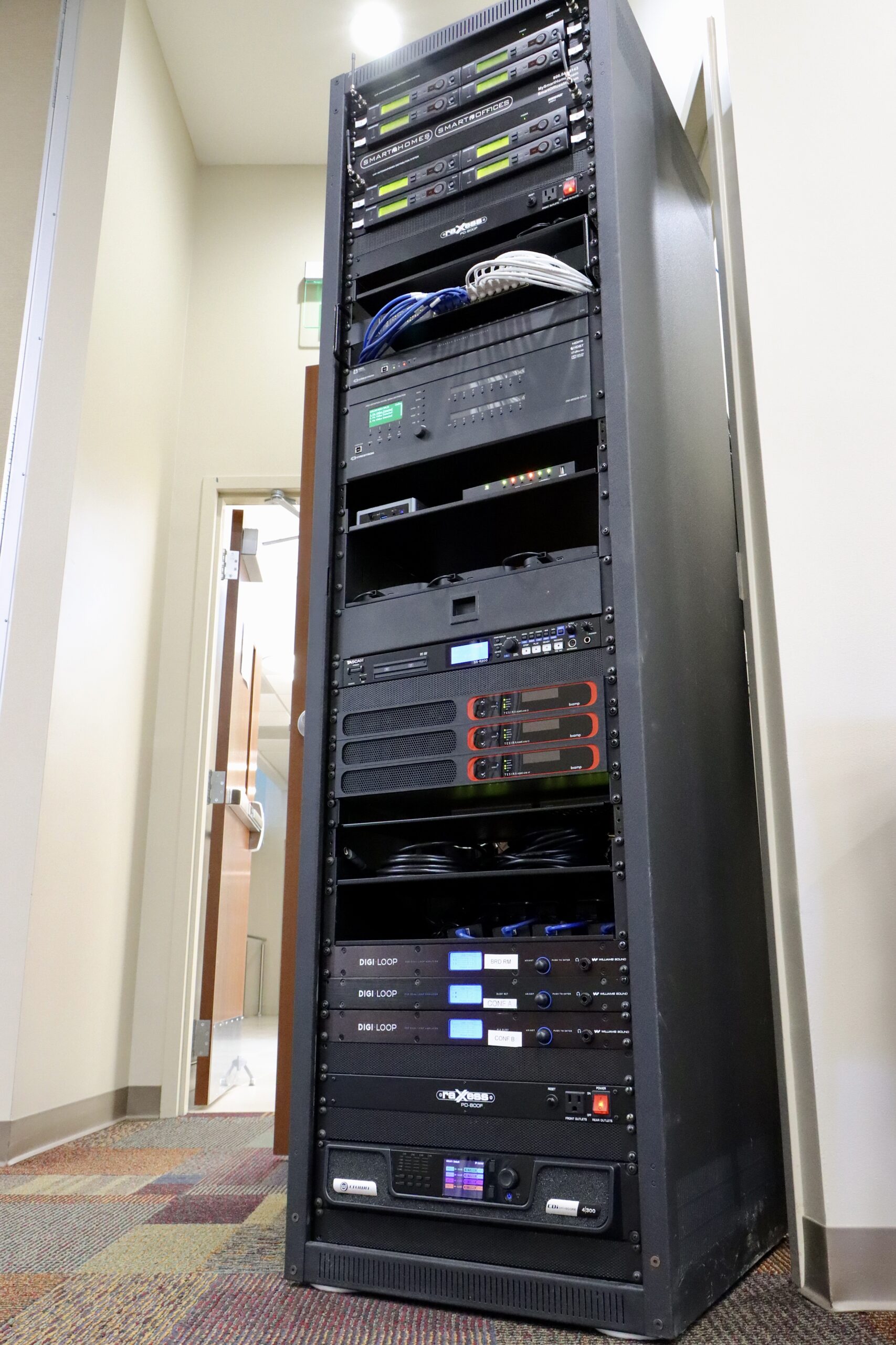 We are looking at a very large equipment rack at an angle from the right