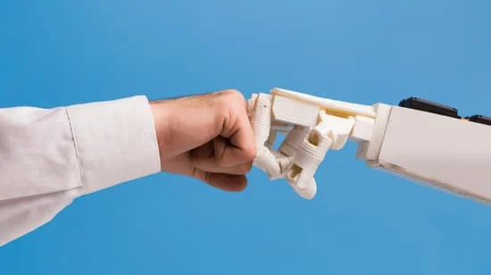 A human hand and robotic hand engage in a fist bump to demonstrate How Creative Professionals are Leveraging AI to Capture New Opportunities