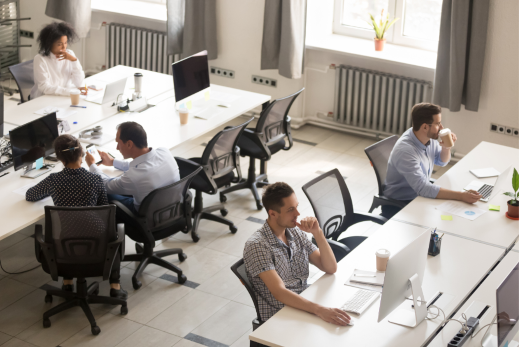 Workers collaborate next to another worker in this post on how to transform your space with sound masking. 